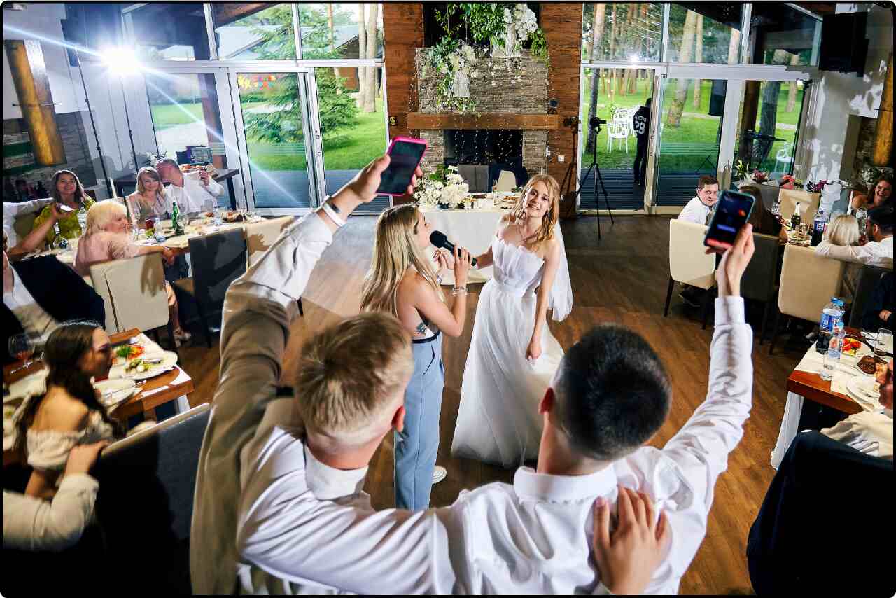 Guests enjoying a live band performance during a wedding reception, with musicians playing instruments on stage.